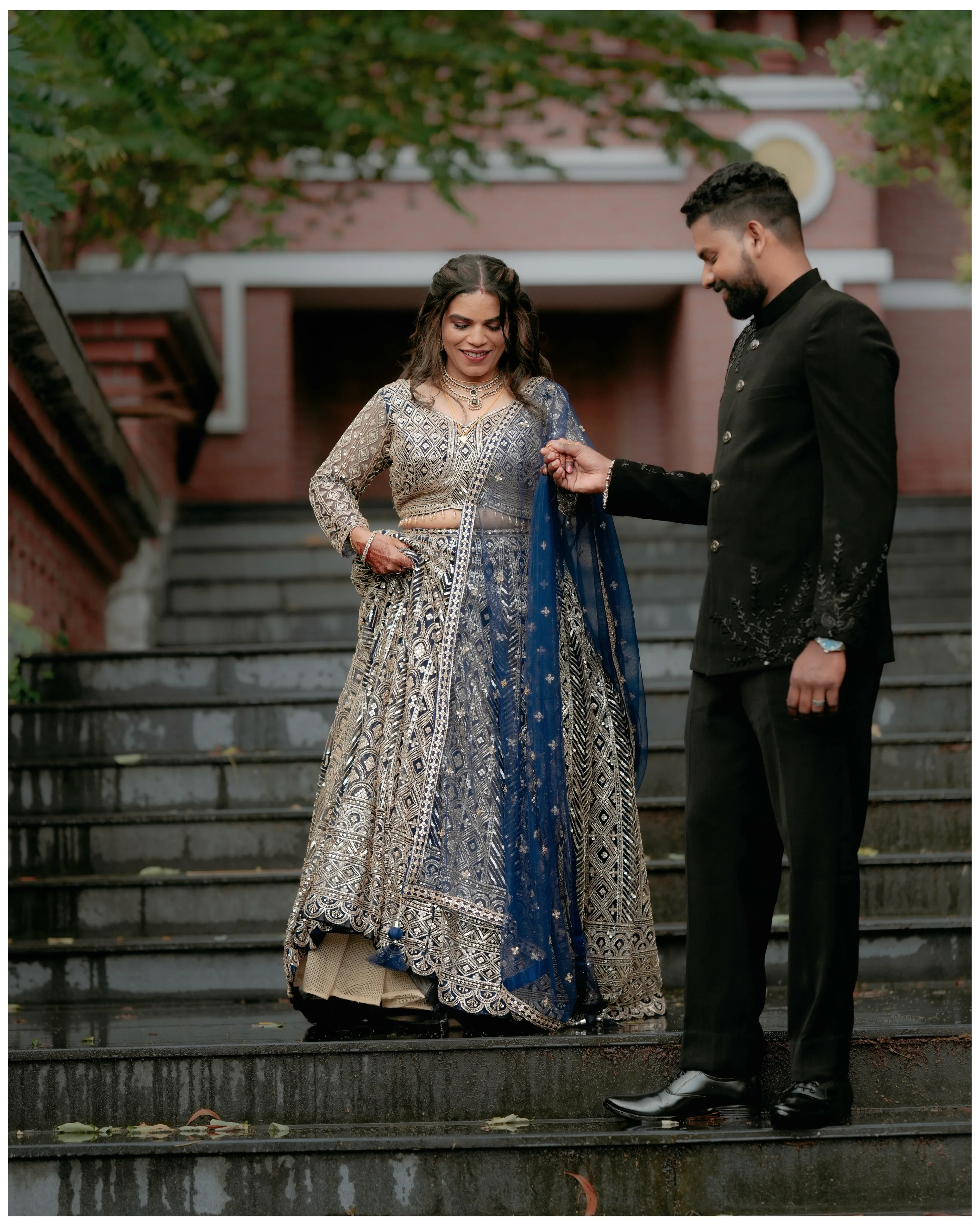 A couple sharing a playful moment together on outdoor steps